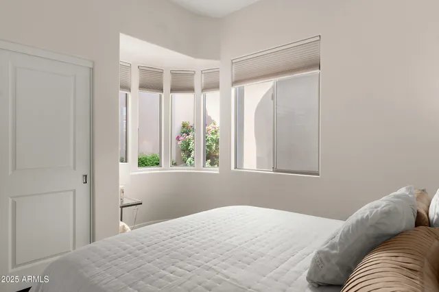 a bedroom with a bed and a window