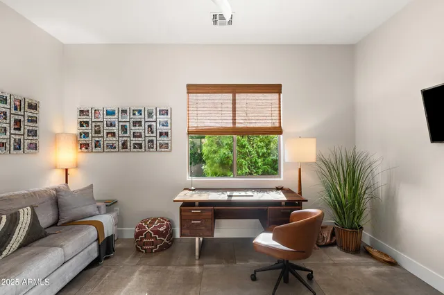 a living room with furniture and a potted plant