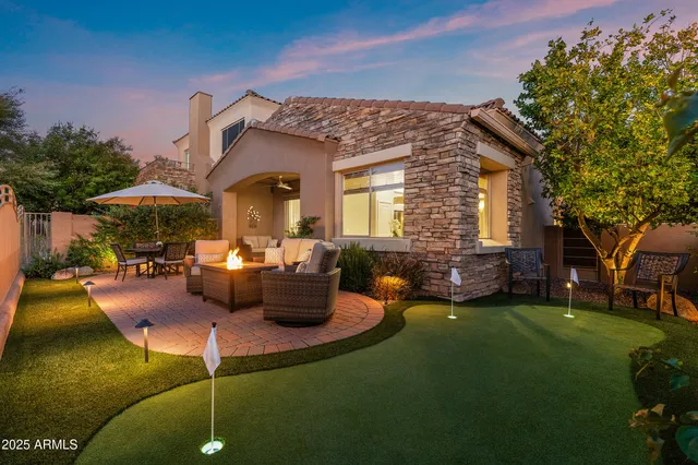 a view of a patio with couches table and chairs and potted plants