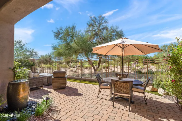 a view of a patio with chairs and tables