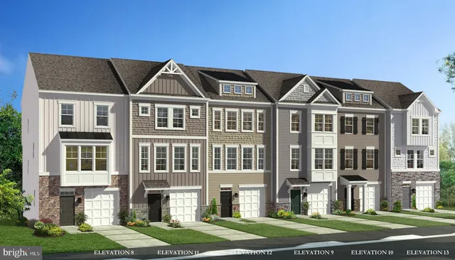 a front view of a residential apartment building with a yard