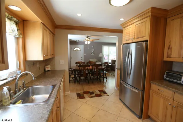 a kitchen with refrigerator cabinets and dining table