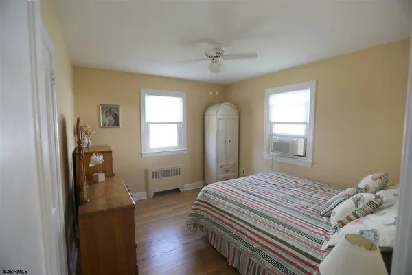 a bedroom with a bed and a dresser