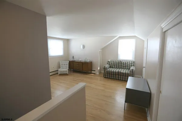 a view of a livingroom with furniture and a window