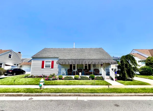 a view of a house in a big yard with palm trees