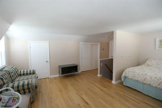 a bedroom with a bed and a couch