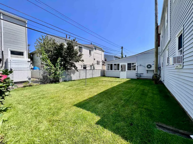 a view of a house with a yard porch and sitting area