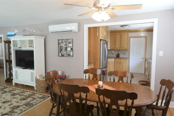 a view of a a dining room with furniture window and wooden floor