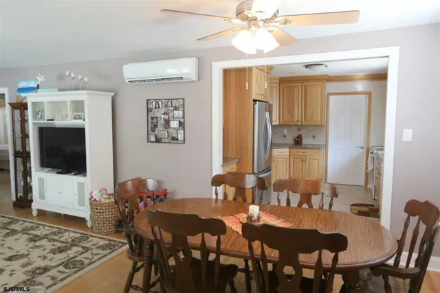 a view of a a dining room with furniture window and wooden floor