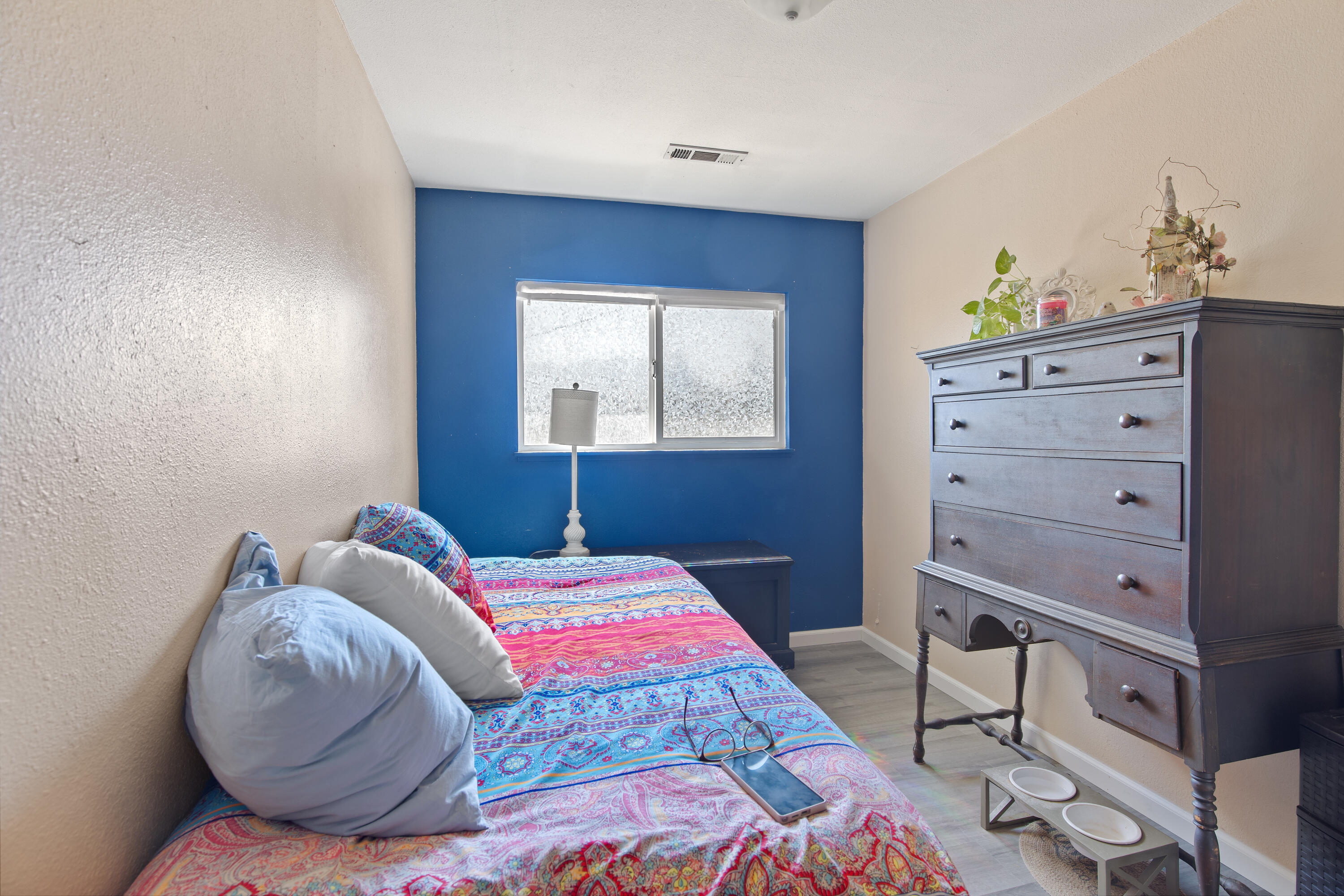12748 Water Gap Road Williams, OR 97544 - Photo 16 of 35 a bedroom with a bed and a dresser