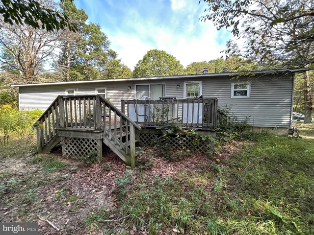 a view of a wooden house with a yard