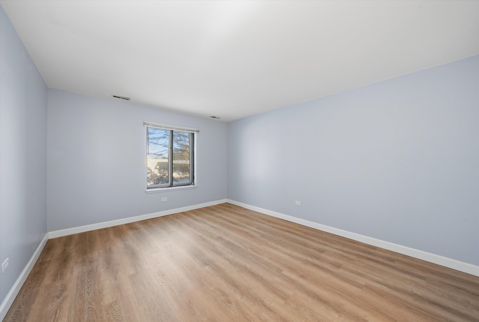 3207 West 184th Street, Unit 1A Homewood, IL 60430 - Photo 14 of 16 an empty room with wooden floor and windows