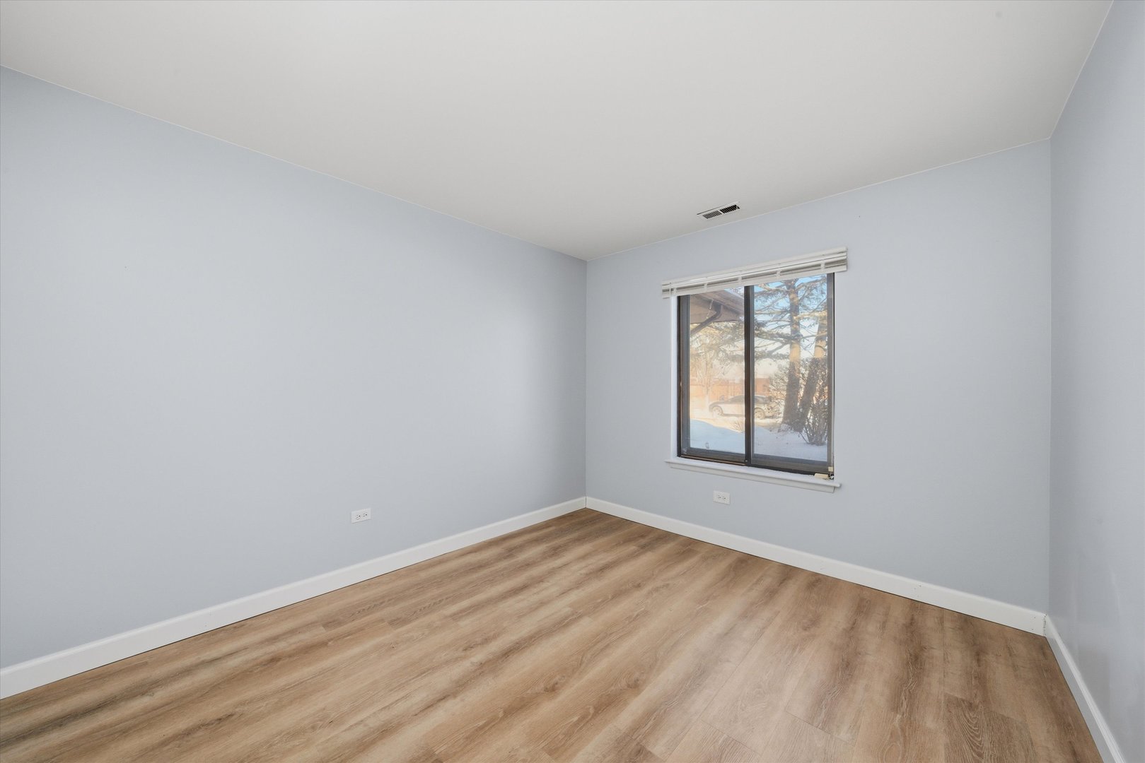 3207 West 184th Street, Unit 1A Homewood, IL 60430 - Photo 16 of 16 a view of an empty room with wooden floor and a window