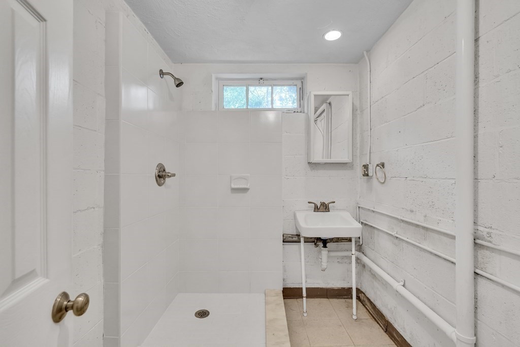 31 Park Drive Newton, MA 02461 - Photo 24 of 31 a bathroom with a tub shower sink and vanity
