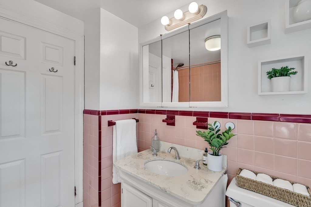 31 Park Drive Newton, MA 02461 - Photo 7 of 31 a bathroom with a sink a vanity and a mirror