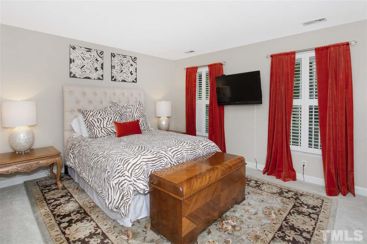 2324 Oxford Road Raleigh, NC 27608 - Photo 26 of 30 a bedroom with a bed and a flat screen tv