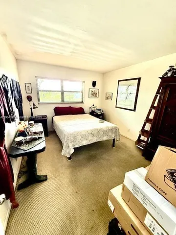 a bedroom with bed and window