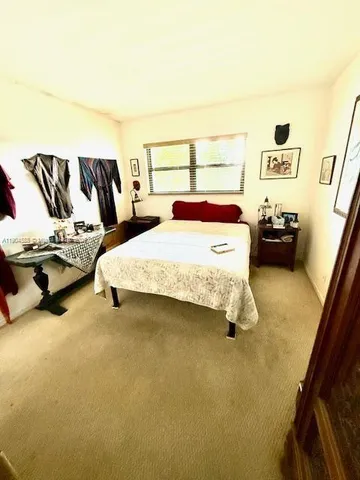 a bedroom with a bed and dresser