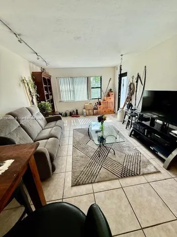 a view of a livingroom with furniture and a flat screen tv