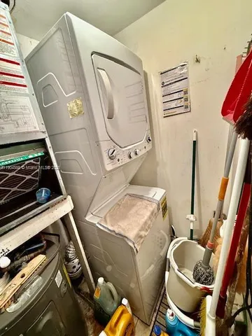 a view of walk in closet with clothes