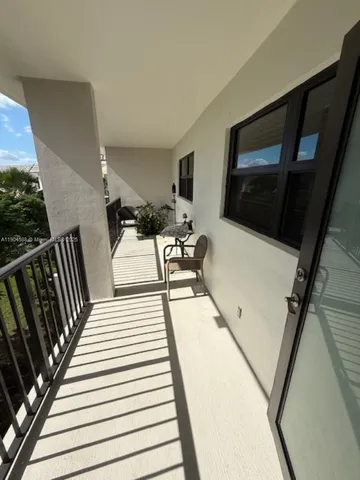a view of a balcony with chairs