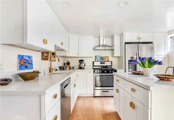 a kitchen with cabinets and stainless steel appliances