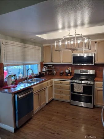 a kitchen with a stove top oven and refrigerator