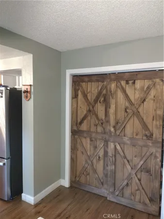 a view of a refrigerator in kitchen and wooden floor