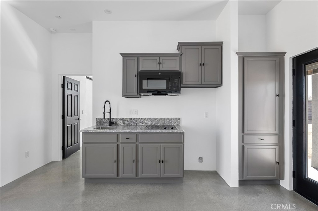 5090 1st Street West Joshua Tree, CA 92252 - Photo 3 of 12 a kitchen with a sink and a refrigerator