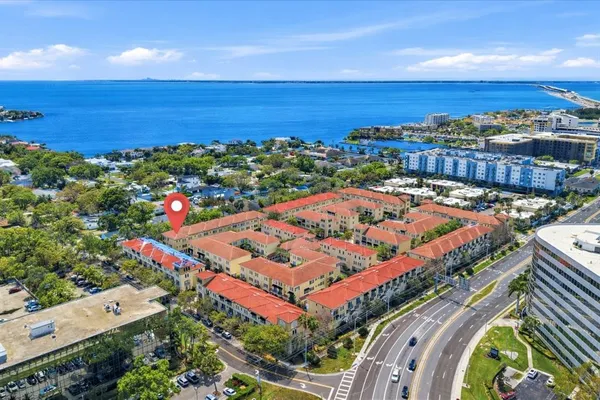 an aerial view of a residential apartment building with a yard