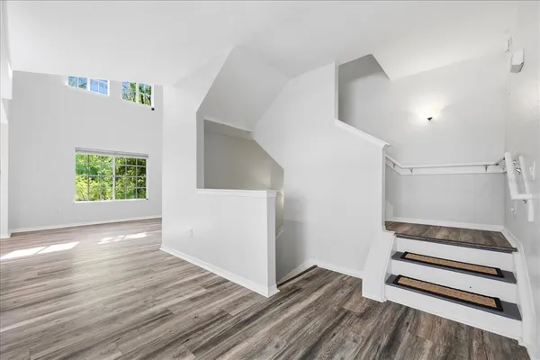 a view of wooden floor and windows in a room