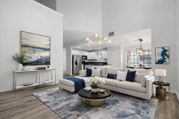 a living room with furniture and kitchen view