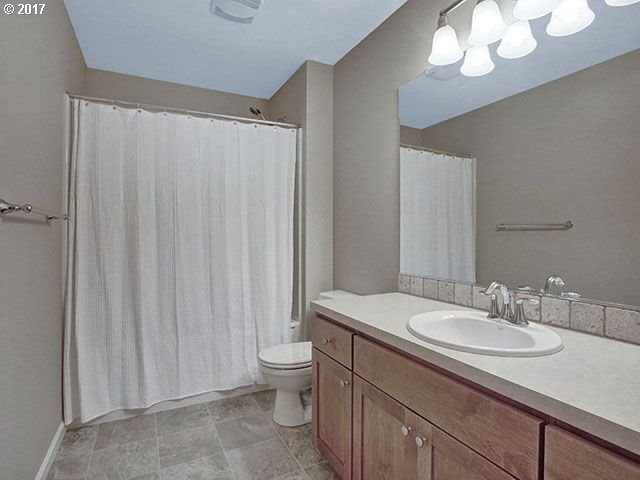9478 Northwest Ember Lane Portland, OR 97229 - Photo 14 of 23 a bathroom with a sink a toilet and a mirror