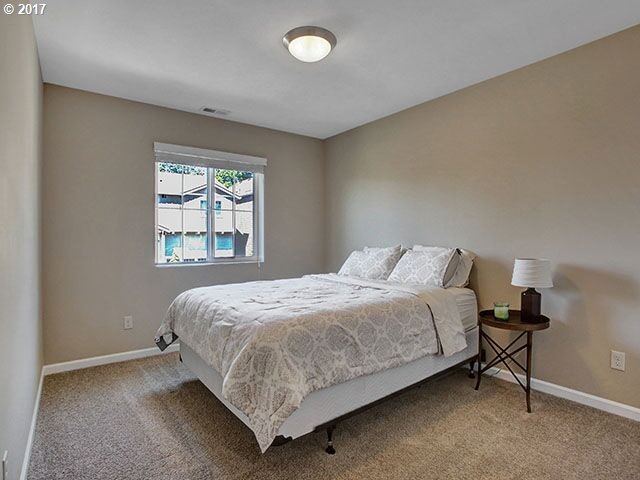 9478 Northwest Ember Lane Portland, OR 97229 - Photo 16 of 23 a bedroom with a bed and window