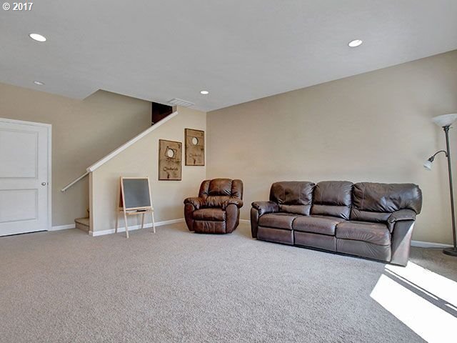 9478 Northwest Ember Lane Portland, OR 97229 - Photo 18 of 23 a living room with furniture and a ceiling fan