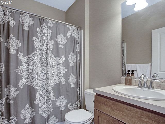 9478 Northwest Ember Lane Portland, OR 97229 - Photo 19 of 23 a bathroom with a sink toilet and shower