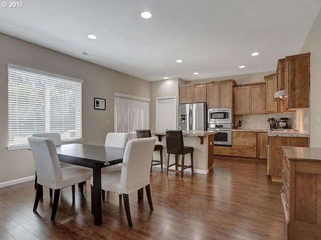 9478 Northwest Ember Lane Portland, OR 97229 - Photo 4 of 23 a view of kitchen with cabinets table and chairs