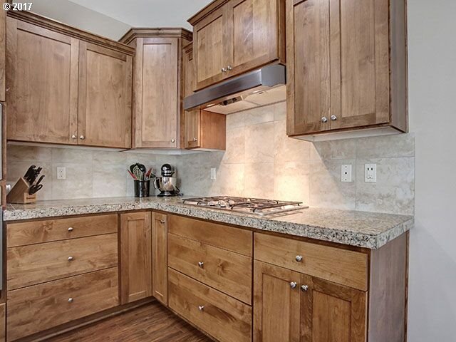 9478 Northwest Ember Lane Portland, OR 97229 - Photo 6 of 23 a kitchen with granite countertop cabinets stainless steel appliances and sink