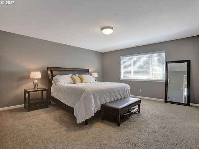 9478 Northwest Ember Lane Portland, OR 97229 - Photo 10 of 23 a spacious bedroom with a bed and window