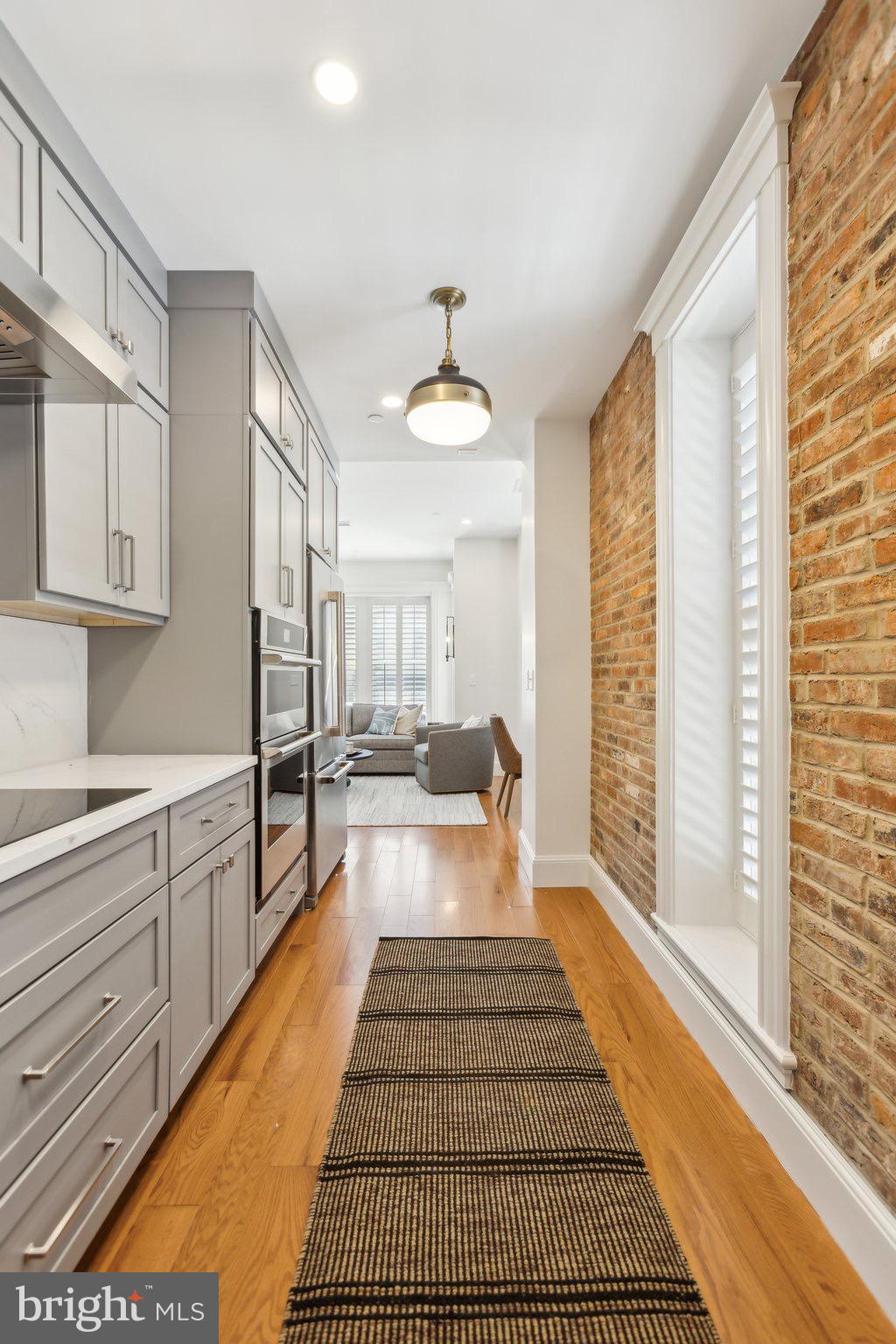 1641 R Street Northwest, Unit 301 Washington, DC 20009 - Photo 10 of 36 Chic kitchen with modern finishes and warmth.