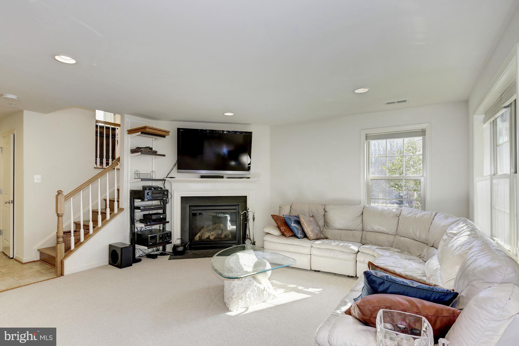 1509 Rabbit Hollow Place Silver Spring, MD 20906 - Photo 22 of 30 a living room with furniture flat screen tv and a fireplace