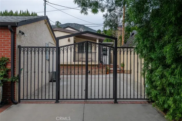 a view of a house with a iron gate