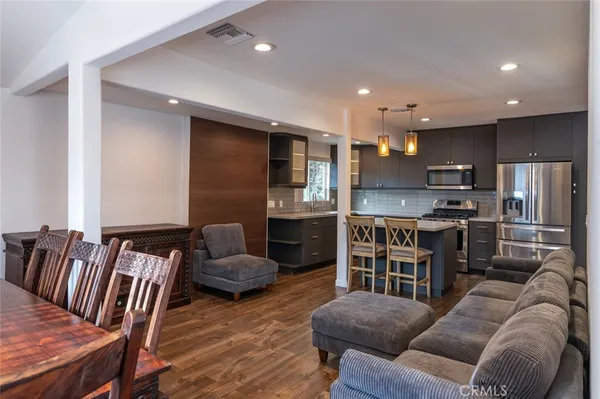 a living room with furniture and kitchen view