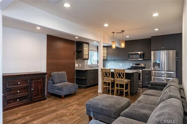 a living room with furniture and kitchen view