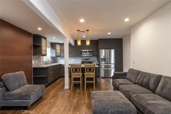a living room with furniture and kitchen view