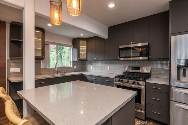 a kitchen with a stove a sink and a microwave