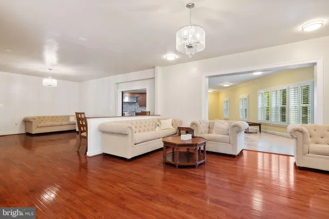 a spacious bedroom with furniture and wooden floor