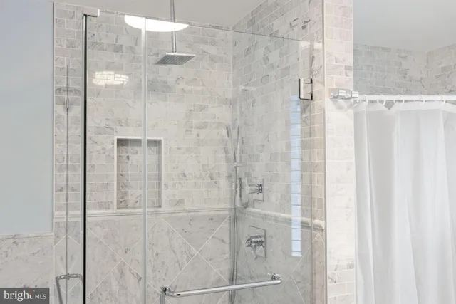 a bathroom with a granite countertop toilet and a sink