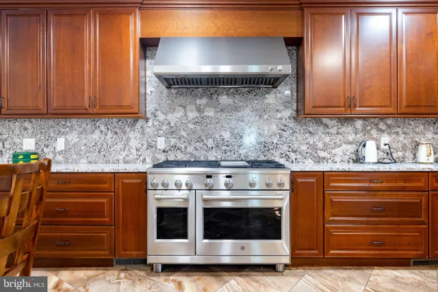 a kitchen with stainless steel appliances granite countertop a stove and a cabinets