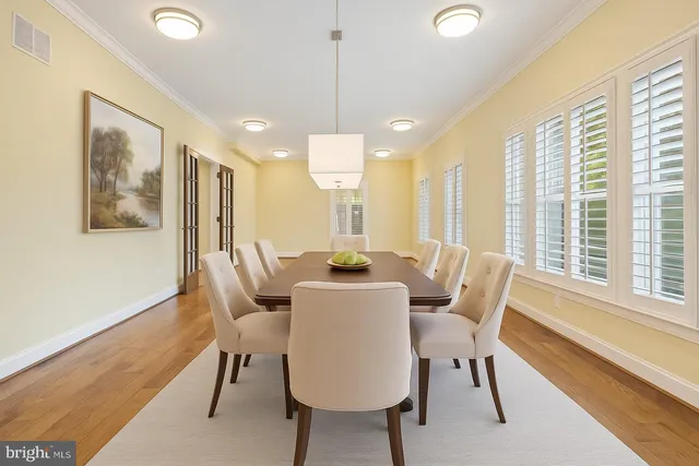a view of a a dining room with furniture window and wooden floor